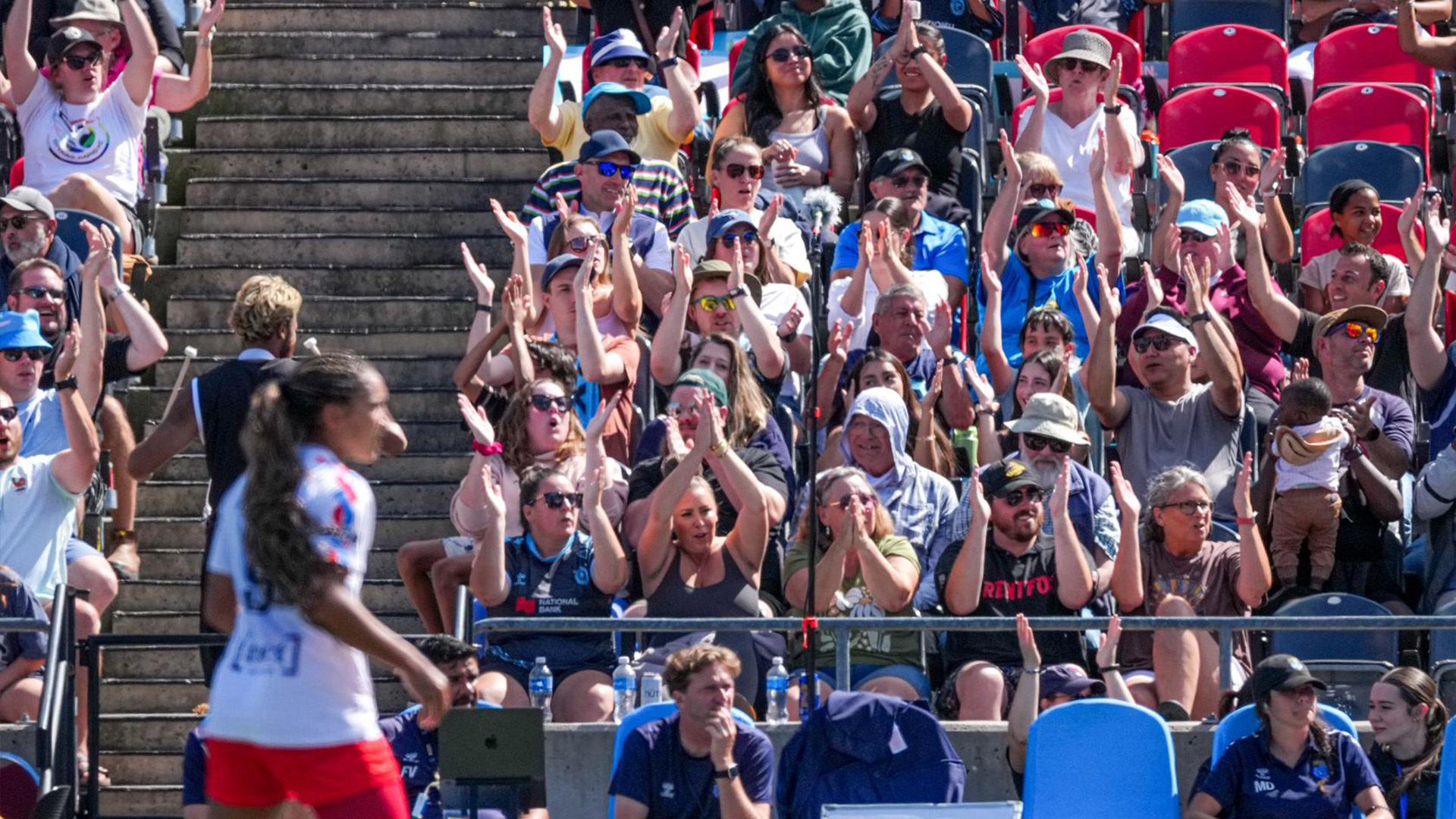 Fans cheer in the crowd for an Ottawa Rapid FC game.